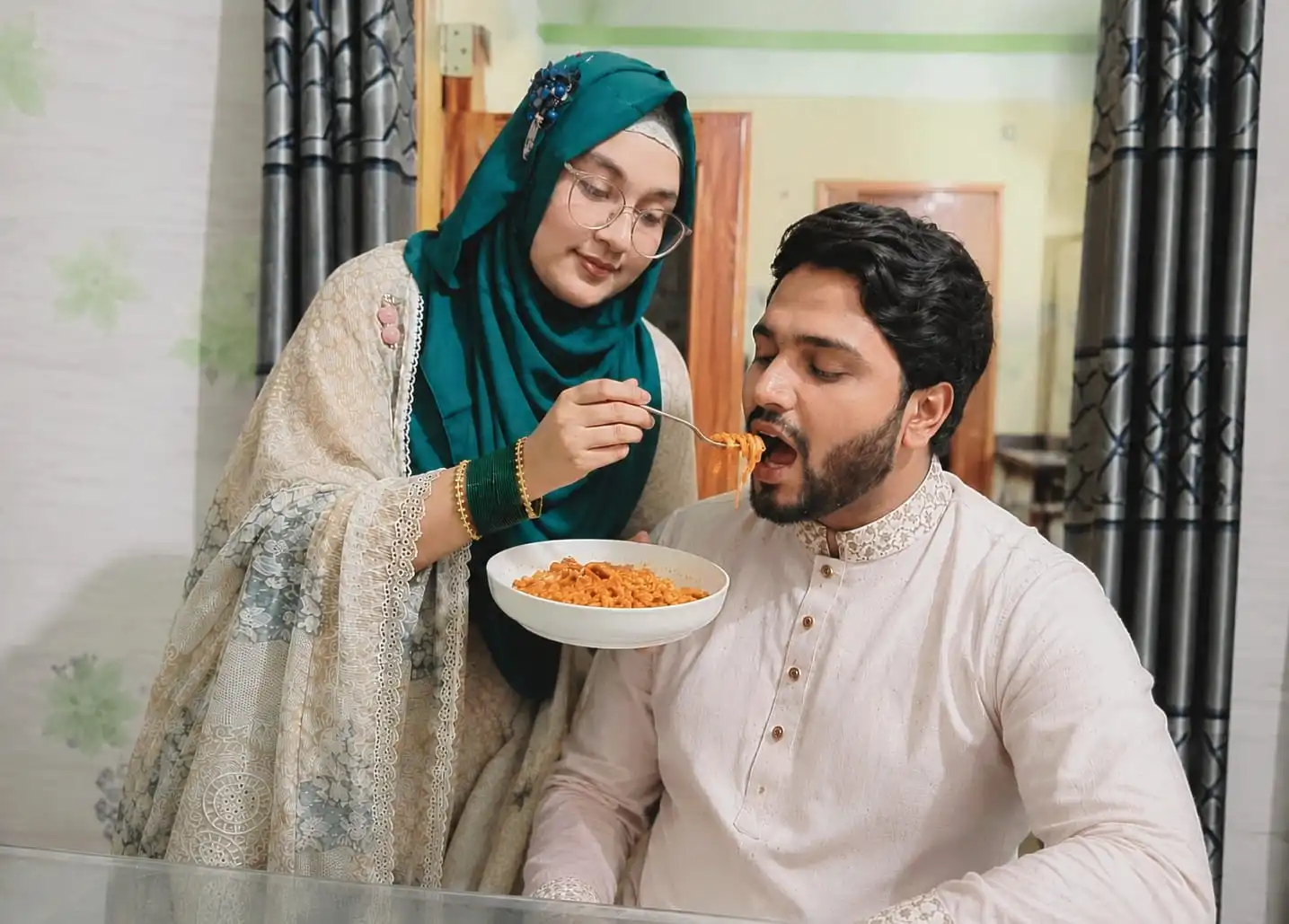Tayuba Tabassum and her husband sharing a meal at home