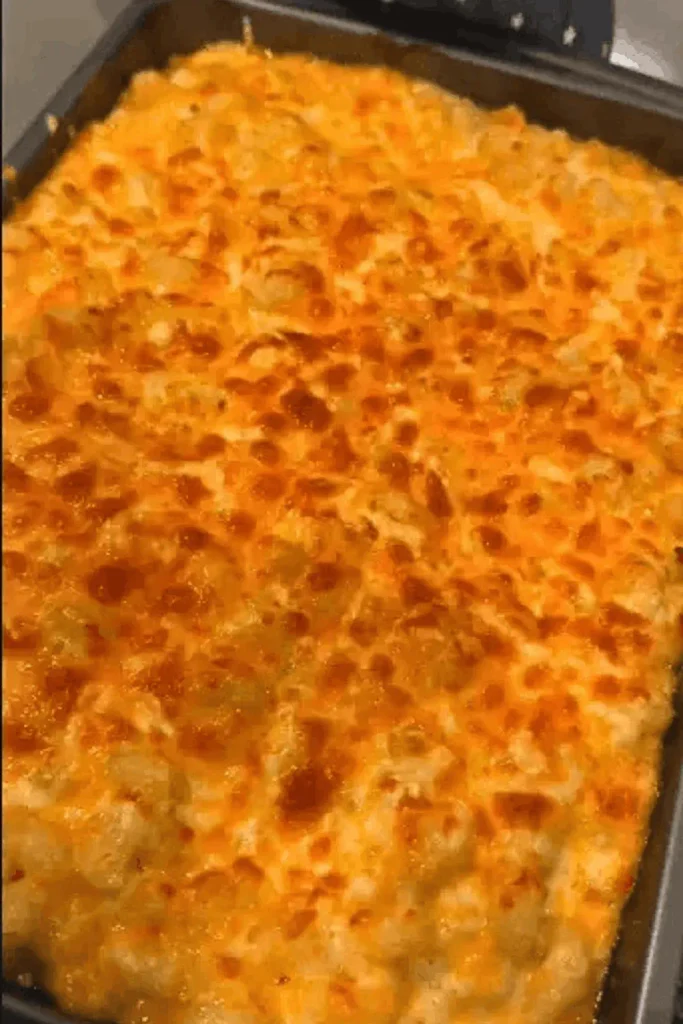 Whole pan of golden baked Paula Deen crockpot mac and cheese with a crisped cheesy top